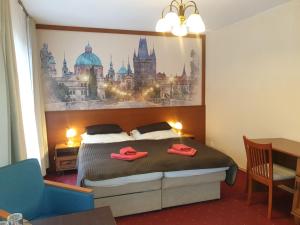 a bedroom with a bed with red slippers on it at Aaron in Prague