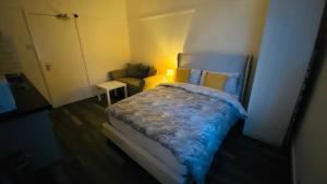 a small bedroom with a bed and a couch at Small Self Contained Studio In Sutton Coldfield in Birmingham