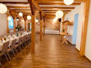 a room with wooden ceilings and tables and chairs at Arka Agroturyska in Kosin