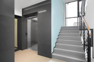 a staircase in a house with a glass door at Elite Apartments Nadmorski Brzeźno in Gdańsk