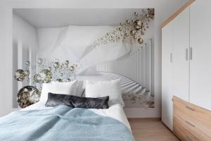 a bedroom with a bed and a staircase at Elite Apartments Nadmorski Brzeźno in Gdańsk +16 photos