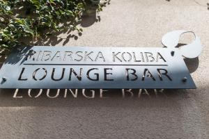 a sign for a louvre bar on the side of a building at Ribarska Koliba Resort in Pula