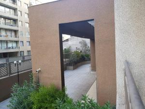 a doorway into a building with a walkway at Departamento A Pasos de Metro Ñuble in Santiago