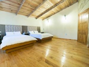 מיטה או מיטות בחדר ב-Collection O Casona De Minas