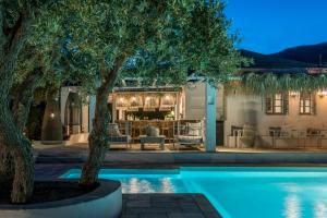 a villa with a swimming pool at night at Verina Terra in Platis Gialos