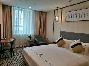 Postel nebo postele na pokoji v ubytování Guangzhou Homies Hotel