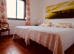 a bedroom with a bed with a painting on the wall at Apartamentos Turisticos Trajano in Bolonia