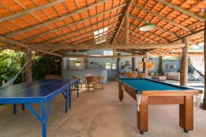 a ping pong room with two ping pong tables at Mandala Maresias in Maresias