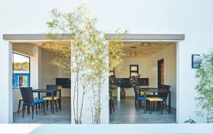 a dining room with black tables and chairs at Rold and Roub Home Suites powered by Cocotel in Puerto Galera