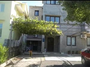 a building with a tree in front of it at Apartman Diana in Kraljevica