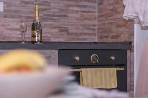 a kitchen with a stove with two bottles of champagne at Modern Apartment Baćo with Jacuzzi in Šibenik