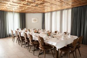 a large room with a long table and chairs at Hotel und Restaurant Wolfensberg in Degersheim