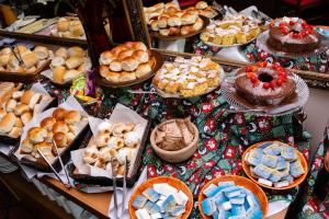 a table filled with pies and cakes and other desserts at Hotel Fazenda Golden Park Campos do Jordão in Campos do Jordão