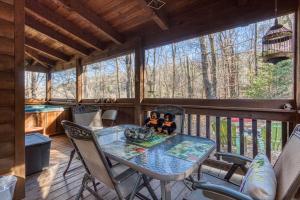 two dolls sitting on a table on a screened in porch at Amberwood- Get 951 worth of FREE area attraction tickets for each paid day!!! in Sevierville