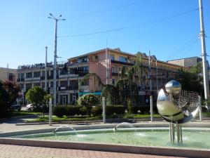 a sculpture of a bird in front of a fountain at Семеен Хотел РОЗА in Kazanlŭk