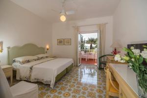 a hotel room with a bed and a balcony at Hotel Villa Maria in Ischia