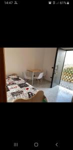 a room with a bed and a table with chairs at CAMERA DELL' ARCO ROMANO in Pozzuoli