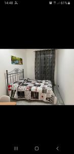 a bedroom with a bed with a quilt on it at CAMERA DELL' ARCO ROMANO in Pozzuoli