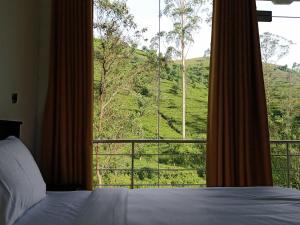 a bedroom with a bed and a view of a mountain at Greenfield Bedz in Hatton