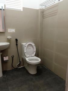 a bathroom with a toilet and a sink at Greenfield Bedz in Hatton