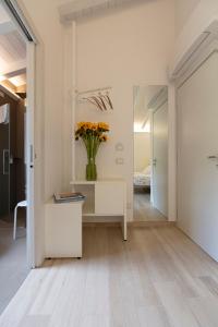 a hallway with a vase of flowers on a table at ARIA Design B&B Levanto in Levanto