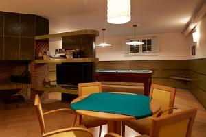a living room with a table and a pool table at La Mama in El Gurb