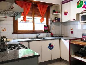 a kitchen with a sink and a stove top oven at Hostel Punto Patagónico Neuquén in Neuquén
