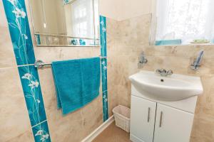 a bathroom with a sink and a mirror at Cherry Garden B&B in Folkestone