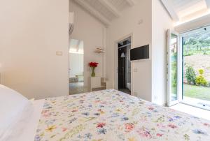 a white bedroom with a large bed and a window at ARIA Design B&B Levanto in Levanto
