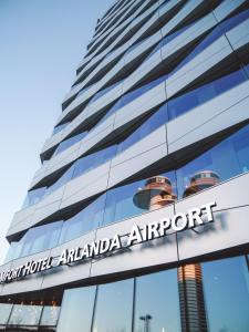 a large building with a sign on the side of it at Comfort Hotel Arlanda Airport Terminal in Arlanda