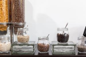 a group of four jars filled with nuts and seeds at Gran Hotel Fray Bentos in Fray Bentos +46 photos