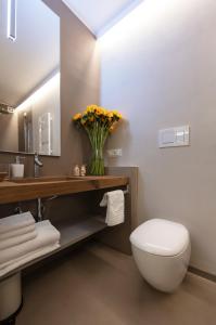 a bathroom with a toilet and a sink and a mirror at ARIA Design B&B Levanto in Levanto