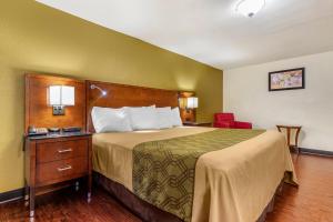 Postel nebo postele na pokoji v ubytování Rose City Inn & Suites