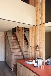 a wooden staircase leading up to a kitchen at Hôtel Grandes Rousses in L'Alpe-d'Huez