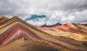 a painting of a mountain with people standing on a hill at ValPer boutique in Cusco