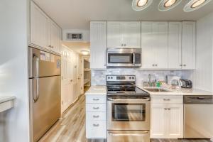 a kitchen with white cabinets and stainless steel appliances at Sea Cabin 347-C in Isle of Palms