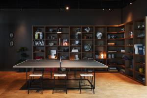 a ping pong table in a room with shelves at Comfort Hotel Arlanda Airport Terminal in Arlanda