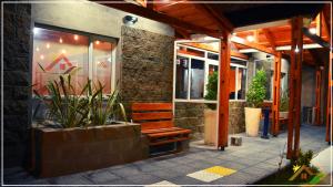 a wooden bench sitting outside of a building at Meraki Las Heras in Las Heras
