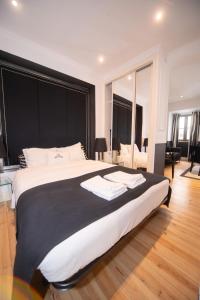 a bedroom with a large bed with a black headboard at Bliss Lisbon Apartments - Bairro Alto in Lisbon