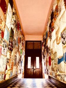 a hallway with a wall filled with mosaic tiles at Polska Poduszka in Lviv