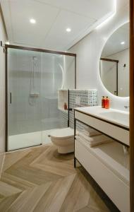 a bathroom with a toilet and a sink and a shower at San Sebastian Suites in Cartagena