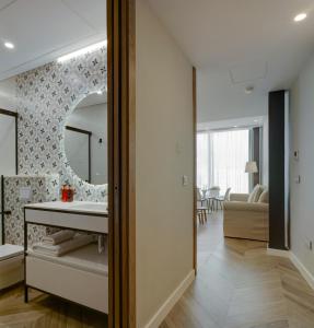 a bathroom with a sink and a mirror at San Sebastian Suites in Cartagena