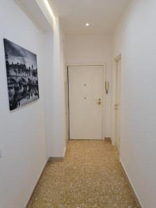 a hallway with a white door and a picture on the wall at Pigneto7 in Rome