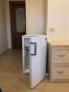 a small white refrigerator in a room with a counter at Villa Costa in Sanzhiyka