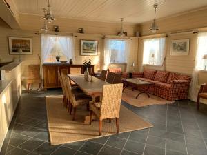 a living room with a table and chairs at Moldegaard Riding Lodge in Moldegard +10 photos
