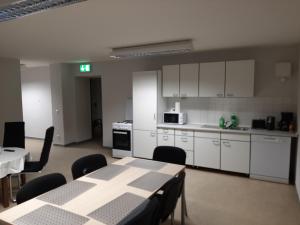 a kitchen with white cabinets and a table and chairs at Monteurwohnung Zentrum in Zerbst