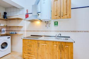 a kitchen with a sink and a washing machine at TREM - LOCATED IN OLD CITY - FARO in Faro