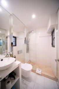 a bathroom with a sink and a toilet and a shower at Bliss Lisbon Apartments - Bairro Alto in Lisbon