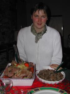 a woman sitting at a table with a tray of food at Le Domaine de Rugornou Vras in Brasparts