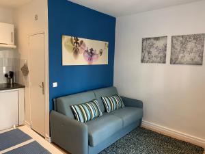 a blue living room with a blue couch at Azur Studios Cannes in Cannes